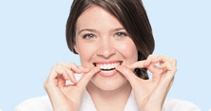Photo of woman placing Invisalign clear aligners